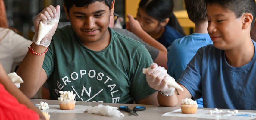 Harsh Patel and Fabian Lopez look at the icing on Patels cupcake.