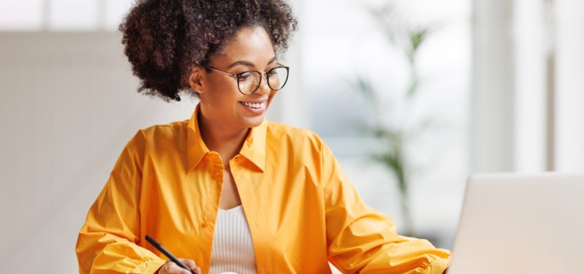 Beautiful,Smiling,African,American,Woman,Works,Remotely,On,Laptop,From