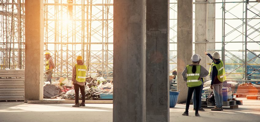 Construction engineers supervising progress of construction proj